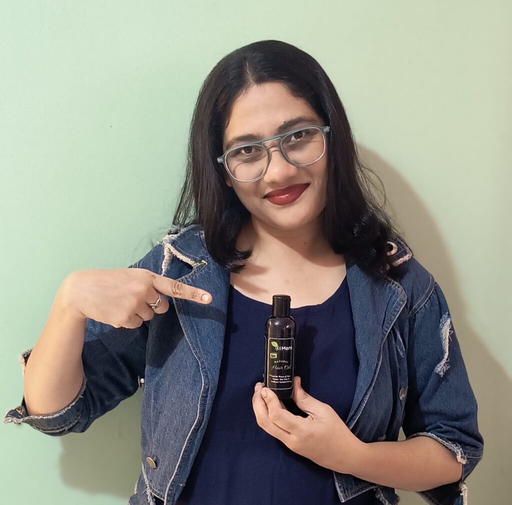 Amazon Kalonji oil bottle by Oilment with black seeds and wooden background